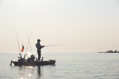 Young Man Kayak Fishing at Sunrise in Canada